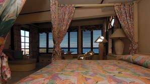 A hotel room with a large bed, a desk, a chair, and a window with blinds. - 5BR Villa, Pool & Little Bay Views (Little bay)