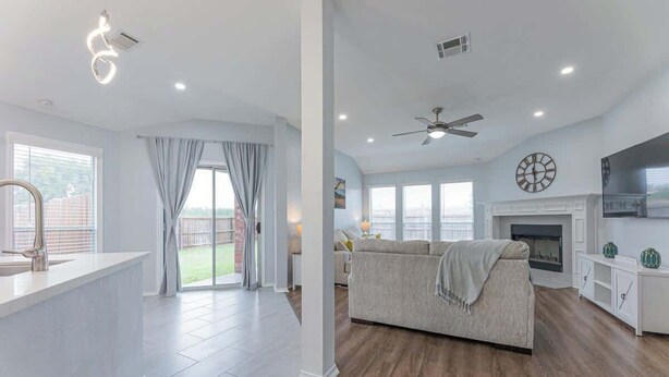 A spacious living area with a fireplace, a sofa, and a kitchen island. - Luxury Harker Hideaway Relax, Unwind, Ex (Harker Heights)