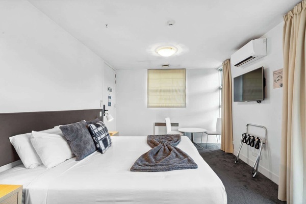 Spacious bedroom with king bed and Smart TV.