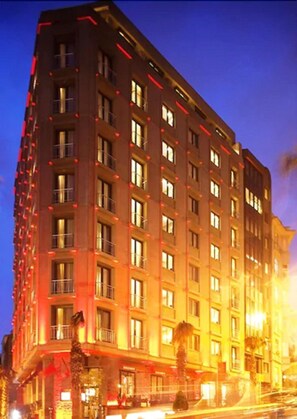 A multi-story hotel with a modern design, featuring balconies and a uniform facade. - Tunel Residence (Istanbul)