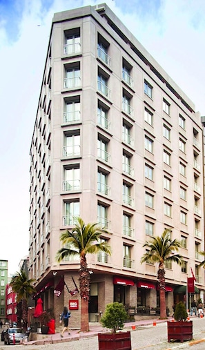 A multi-story hotel with a uniform facade, balconies, and a ground-level restaurant. - Tunel Residence (Istanbul)