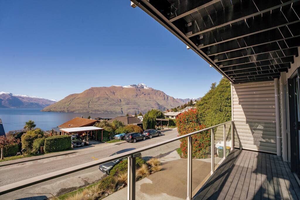 A residential area with a view of a mountain and a lake.