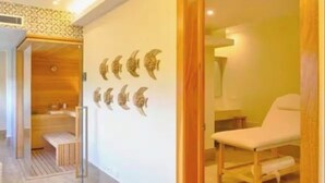 A modern interior with a wooden floor, a massage chair, and a wall with moon-shaped decorations. - A paradise in the Caribbean (Playa Juan Dolio)