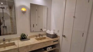 A modern bathroom with a large mirror, a sink, and a toilet. - A paradise in the Caribbean (Playa Juan Dolio)