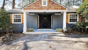 A two-story house with a dark gray exterior, a wooden shingle roof, and a front entrance with a small porch. - Falling Water Suite on Lookout Mountain (Lookout Mountain)