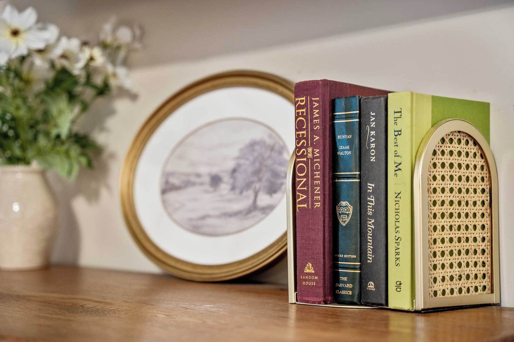 A bookshelf with books and a decorative plate.