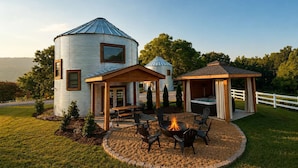 A rustic cabin with a circular structure, a wooden deck, and a hot tub. - Cozy Ridge Silo - Sleeps 6 with Private Hot Tub (Chattanooga)
