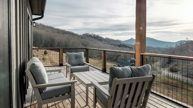 A balcony with outdoor furniture and a scenic view of mountains. - Luxe | 8BR 6 Kings | Sleeps 22 | 2HotTub | Firepit (Banner Elk)