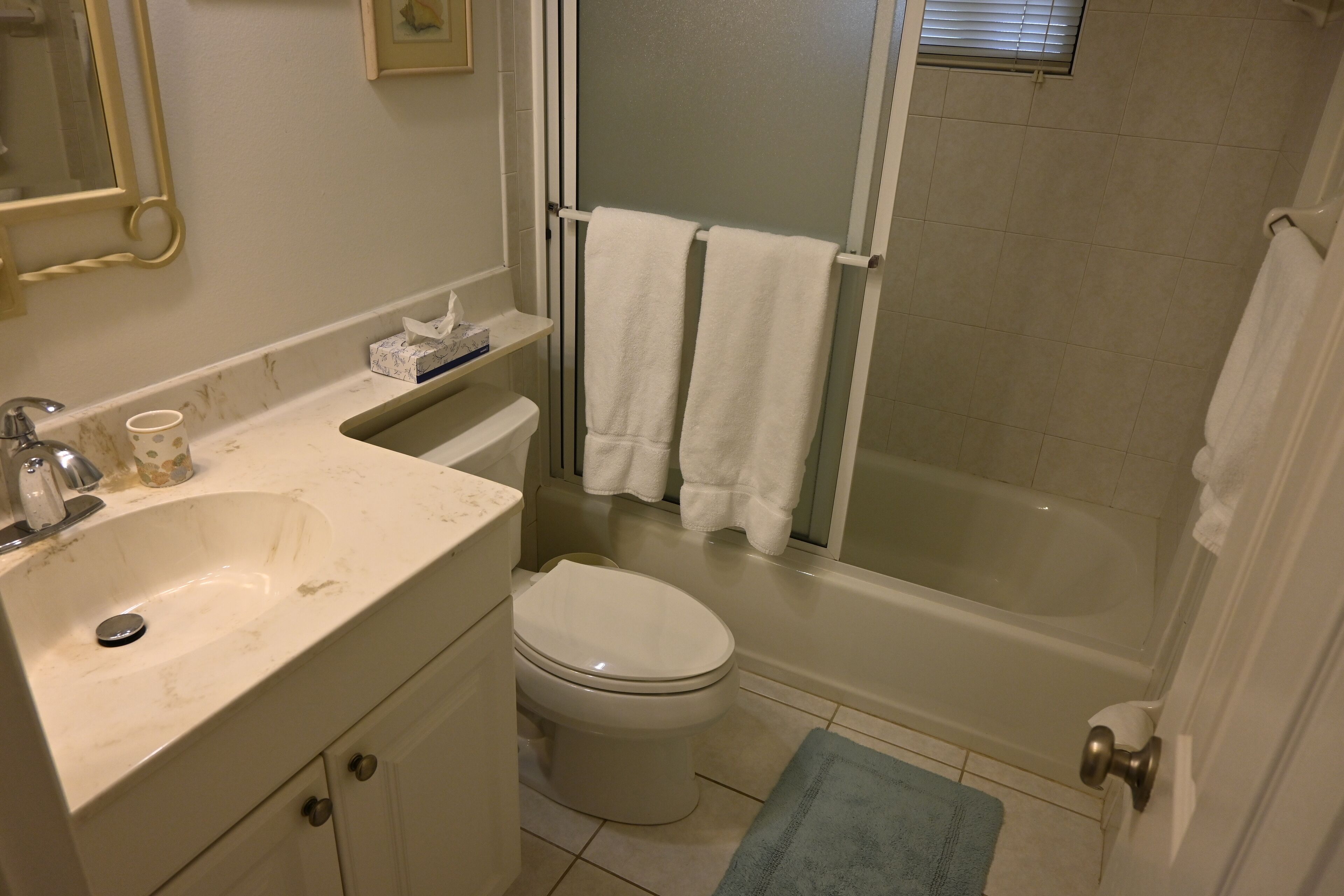 A bathroom with a sink, toilet, and bathtub.