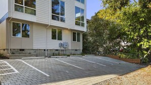 A modern building with large windows and a parking lot. - 2026 World Cup | Rooftop View, Light Rail, Parking (Seattle)
