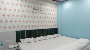 Quarto com cama, mesa de cabeceira e ventilador de teto.