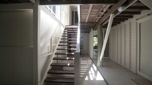 A staircase with a modern design, leading to an upper level. - Windjana Wongaling Beach (Wongaling Beach)