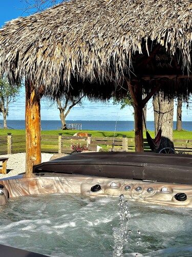 Escape to this stunning bayfront retreat in Beach City, where art meets nature!