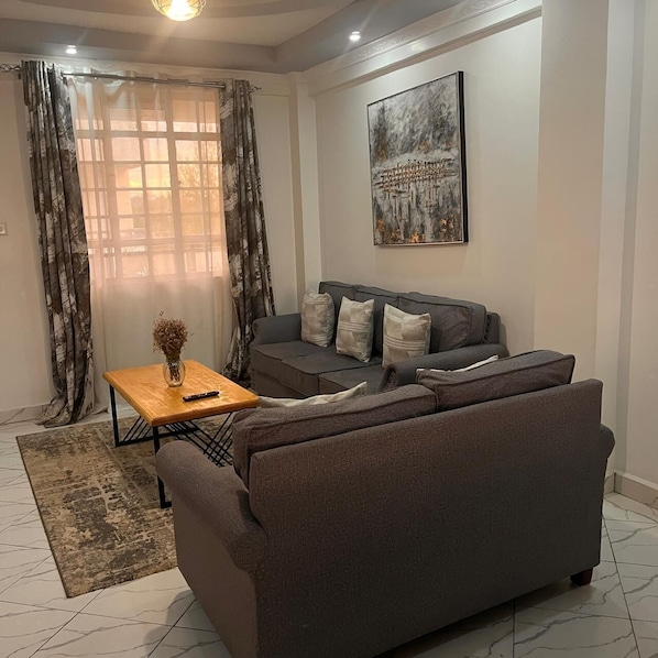 Deluxe Apartment, Garden View | Living area | 32-inch Smart TV with digital channels - Koselig Homes califonia Plaza Nanyuki (Nanyuki)