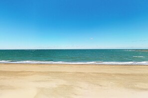 A beach with clear blue water and a sandy shore. - Walk to Sandhills Beach! Sunny Group Getaway (Scituate)