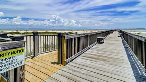 A wooden boardwalk leading to a beach with a 'Private Property' sign. - Hilton Head Haven: Beach House Lookout w/ Pool (Hilton Head Island)