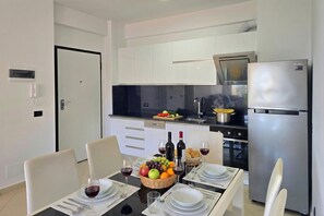 Cafetera o tetera, frigorífico, horno y placa de cocina