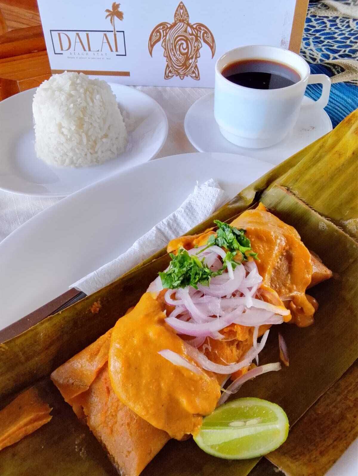 A meal with rice, a cup of coffee, and a wrapped dish garnished with onions and cilantro.