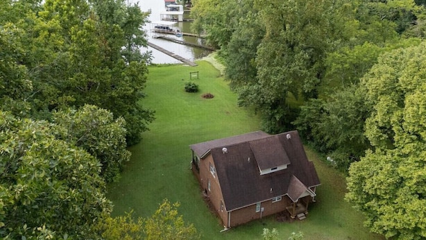 A house with a large yard and a dock extending into a lake. - Elk River Retreat, in Rogersville AL (Rogersville)