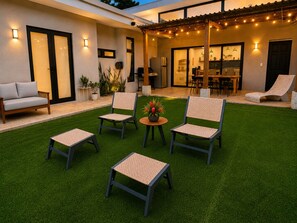 A patio with four chairs, a table, and a grill area. - 3-bedroom house with private pool, AC, fitness center-5min from the sand. (Provincia de Guanacaste)