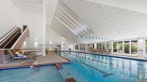 An indoor swimming pool with a staircase, lounge chairs, and a view of the outdoors. - Homestead Hideaway - Amenities, Mins from Skiing (Edwards)