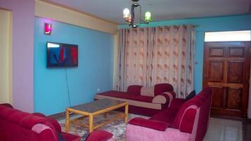 Classic Apartment, City View | Living area | 32-inch Smart TV with digital channels