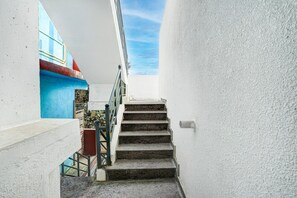 A narrow stairway with a metal railing, leading to a higher floor. - Classic GM Comdorts (Bengaluru)