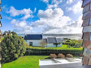 A residential area with a view of the sea, houses with sloped roofs, and a well-maintained garden. - Le Clozic by Interhome (Locquirec)