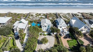 A coastal residential area with houses, a star symbol, and a beach in the background. - Oceanfront Home! Spectacular Sunrise and Sunset Views, Private Boardwalk to Beach, Two Balconies! (St. Augustine)