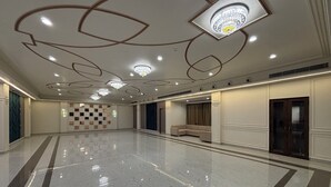 A spacious, well-lit hotel lobby with a polished marble floor, a seating area with sofas, and a decorative ceiling with recessed lighting and chandeliers. - Hotel Shree Rajasthan Inn (Ajmer)