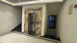 A hallway with a worn door, a staircase, and a small window. - Hotel Shree Rajasthan Inn (Ajmer)