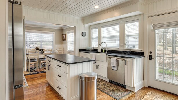 A kitchen with white cabinetry, a stainless steel refrigerator, and a large island. - 1 Block to Dtwn Lewisburg! Quiet Home w/ Decks (Lewisburg)