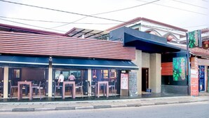 A restaurant with outdoor seating, a visible menu board, and a signboard advertising 'Dialog'. - Seaport Negombo (Negombo)