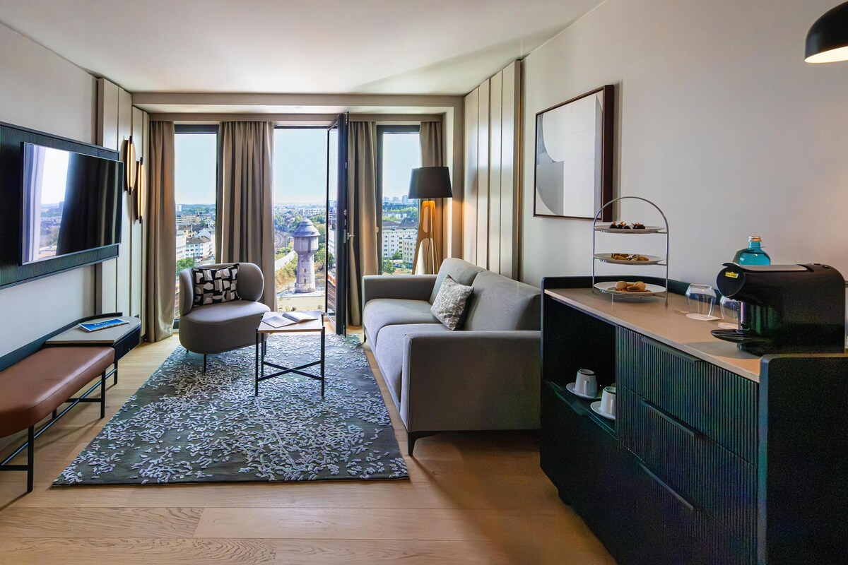 Suite (Skyline) | Living area | 50-inch Smart TV with cable channels, books