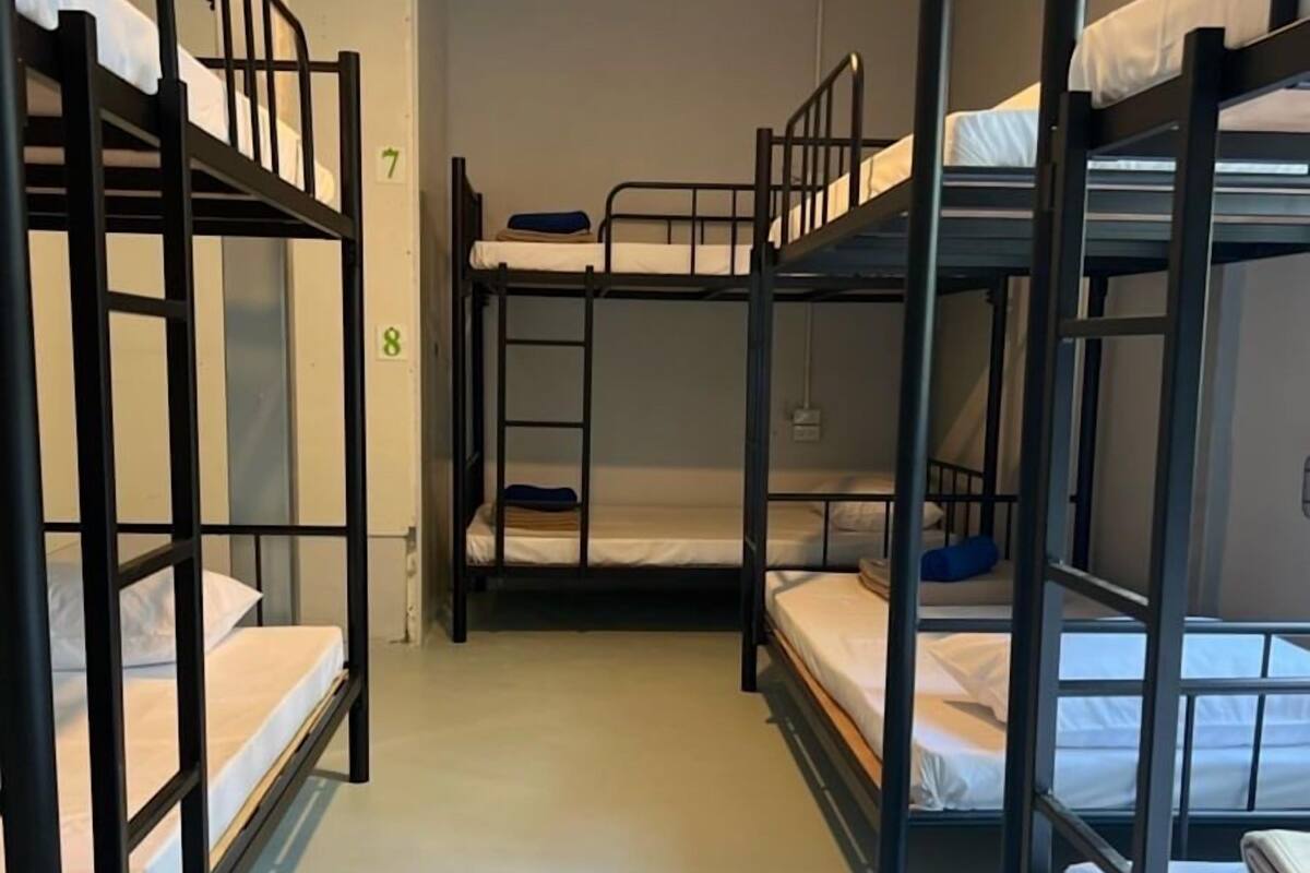 A corridor with bunk beds, numbered 7 and 8, in a dormitory setting.
