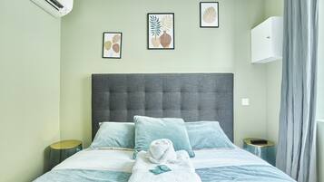 Escritorio, tabla de planchar con plancha y ropa de cama