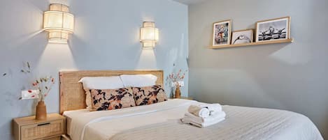 Desk, iron/ironing board, bed sheets