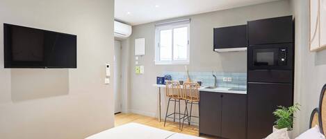 Escritorio, tabla de planchar con plancha, ropa de cama