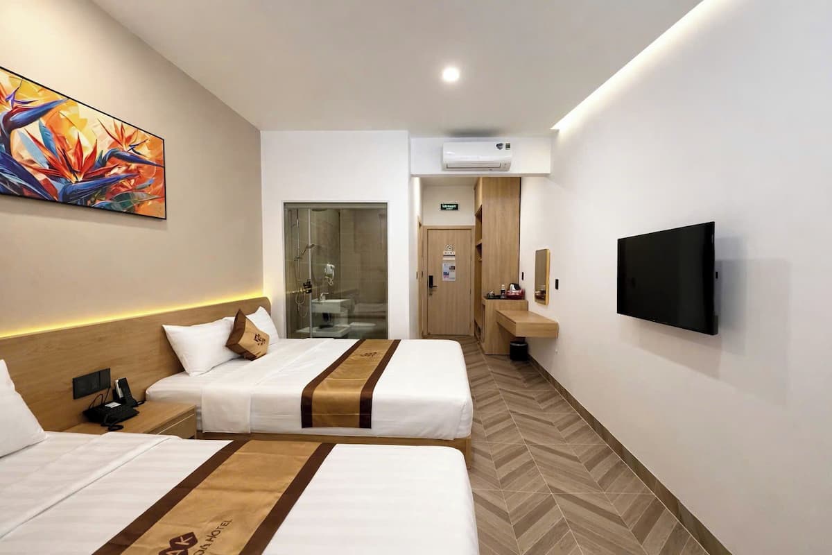 Chambre Deluxe avec lits jumeaux | Minibar, fer et planche à repasser, Wi-Fi gratuit, draps fournis