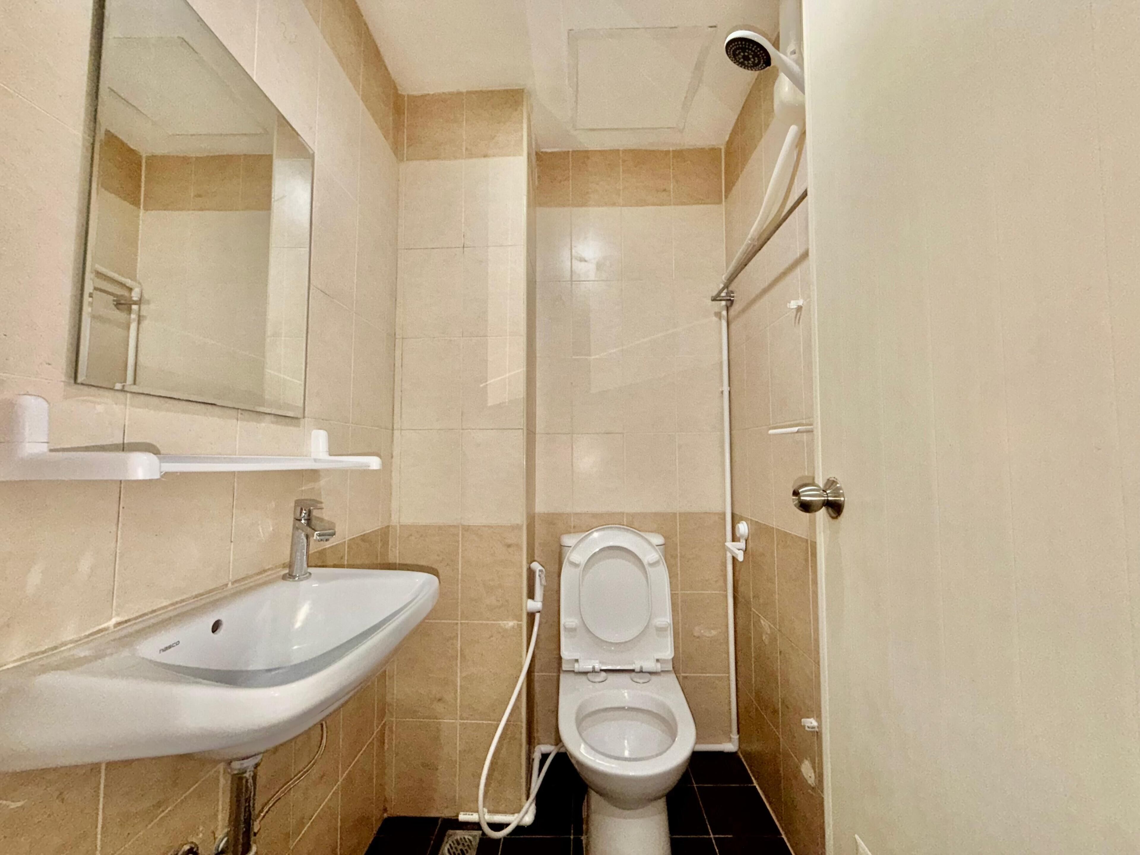A bathroom with a sink, toilet, and shower.