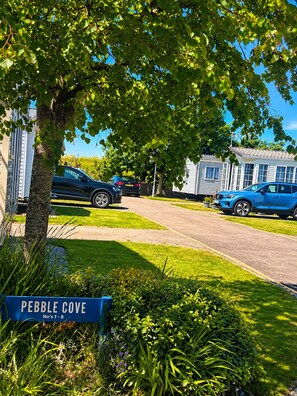 A residential area with a sign reading 'PEBBLE COVE No's 1-8' indicating a housing development.