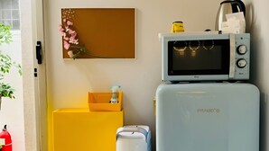 A compact kitchenette with a microwave, refrigerator, and trash bin. - BANANA_Marvelous 1-bedroom studio with AC in EWha Univ. (Seodaemun-gu,)
