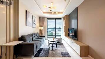 Family Suite, 3 Bedrooms, Club lounge access, City View | Living area | 665-inch Smart TV with cable channels, fireplace, Netflix