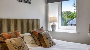 A bedroom with a bed, pillows, a window, and a lamp. - Old Barn at Ormidale House (Glendaruel)