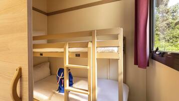 A bunk bed room with a window and a door.