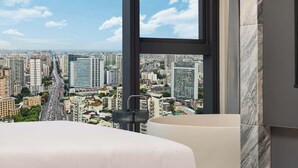 A high-rise hotel room with a large window offering a cityscape view. - Yashan Tianlai S High-Rise Hotel (Chengdu)