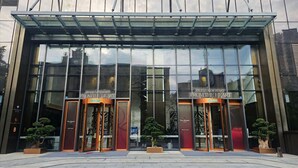 A modern building with glass facade and two entrances labeled "Brand New Start From the Heart". - Yashan Tianlai S High-Rise Hotel (Chengdu)