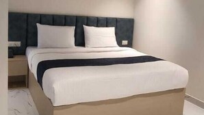 A modern bedroom with a bed, nightstand, and a light fixture. - FRACSPACE PRIVATE LIMITED (Hyderabad)