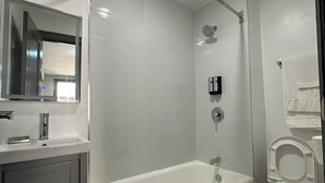 Ein modernes Badezimmer mit Badewanne, Toilette und Waschbecken.