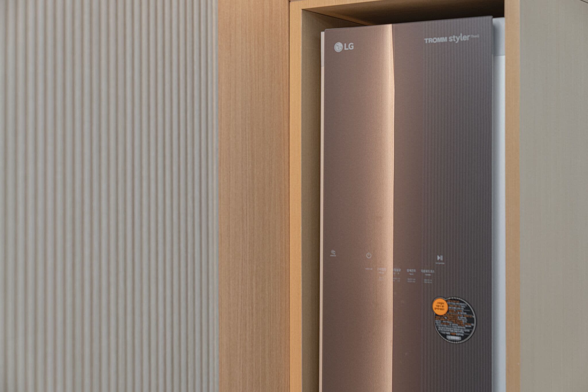 A modern elevator with a metallic finish and a control panel with a circular button.